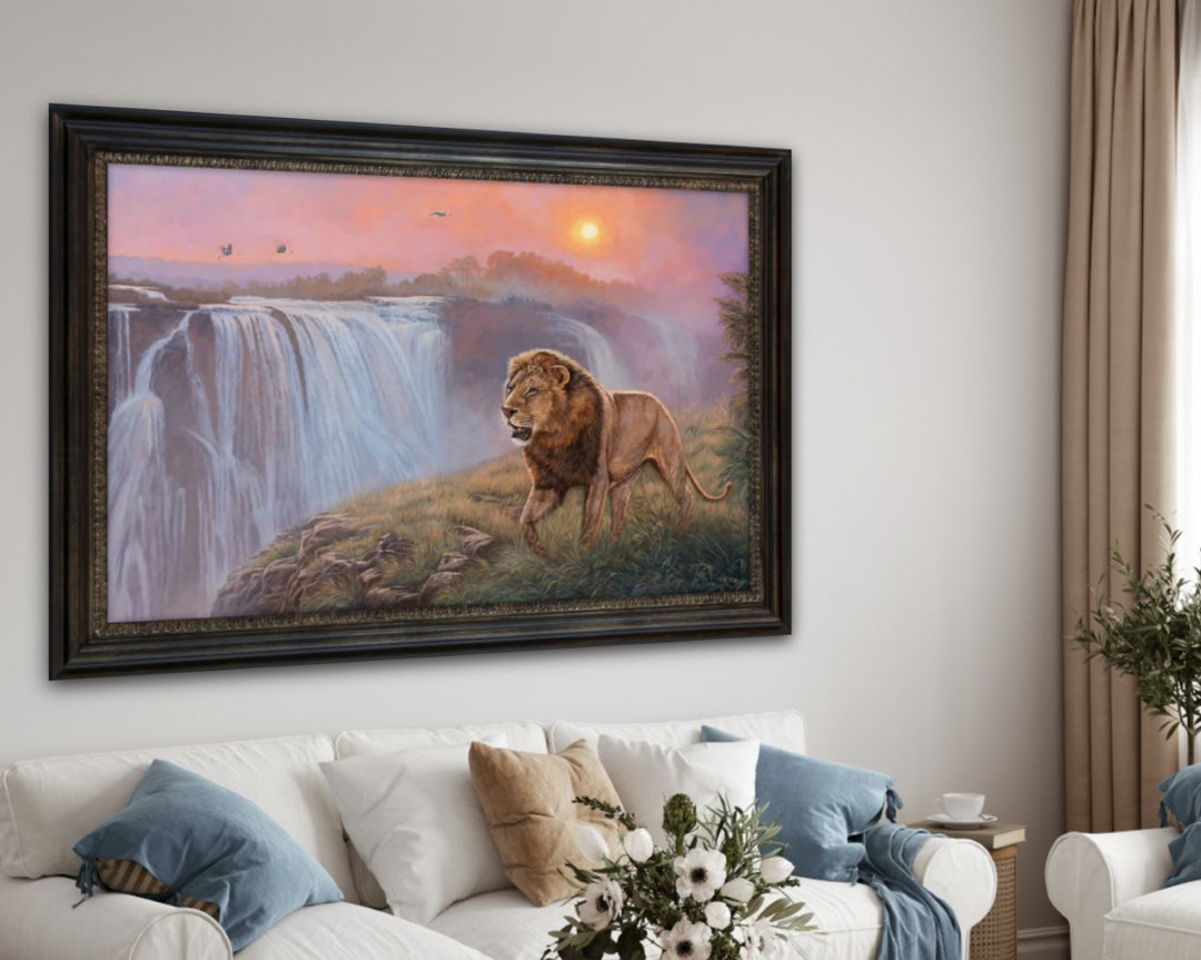 Framed painting of a lion by a waterfall in a living room setting.