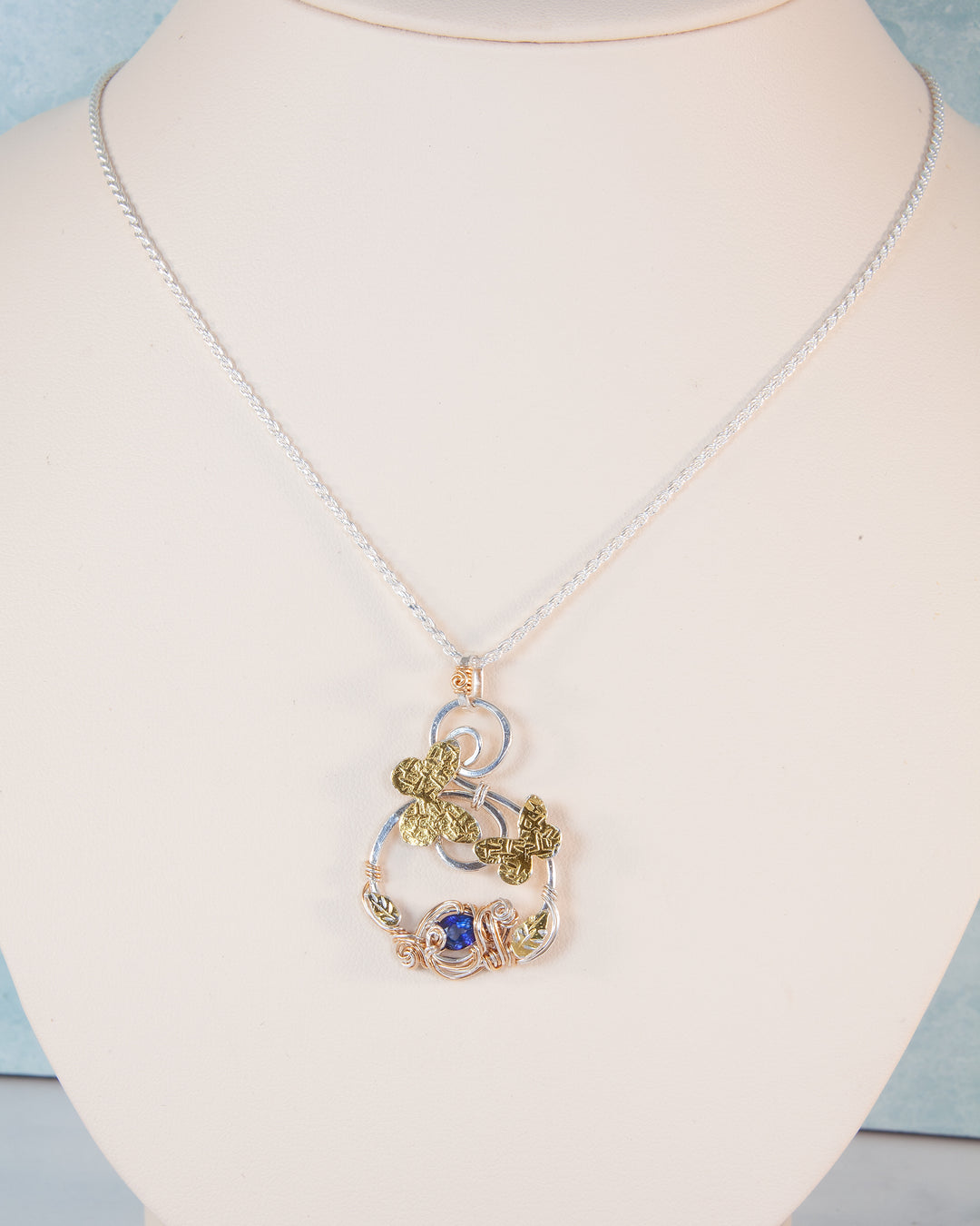 Necklace with a detailed pendant on a mannequin