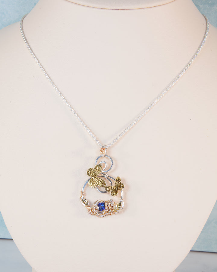Necklace with a detailed pendant on a mannequin