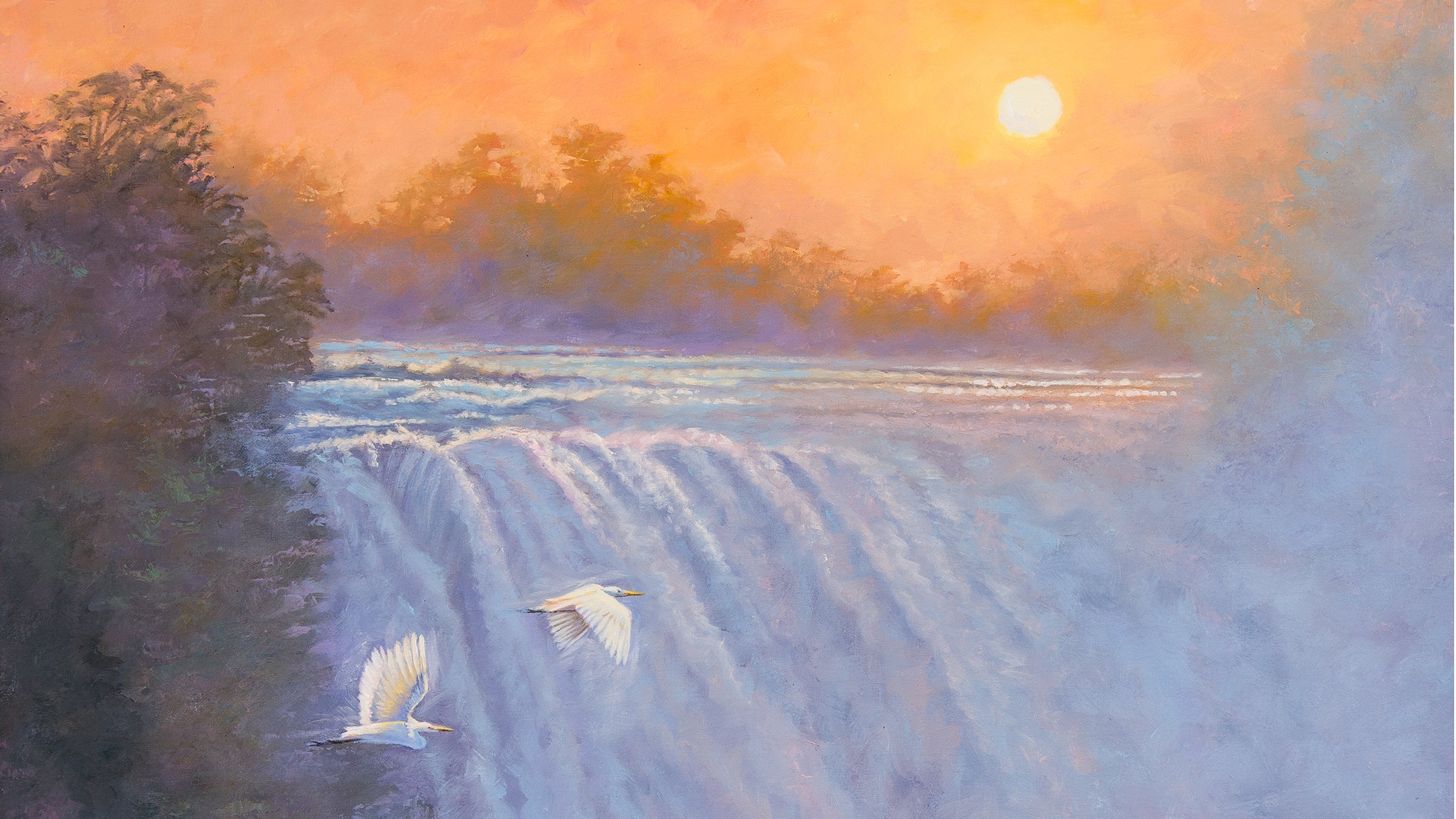 Two birds flying over a river at sunset with trees in the background