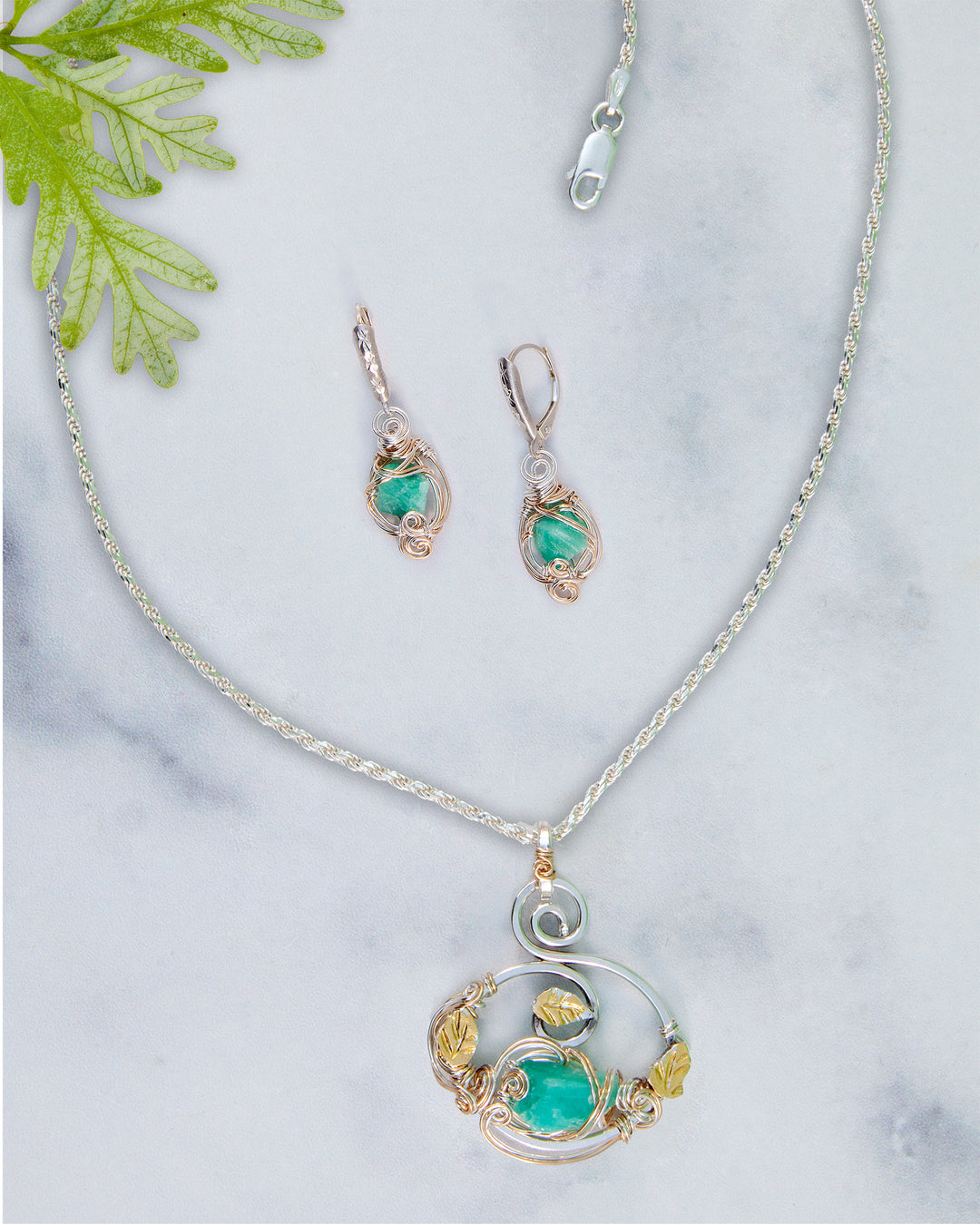 Jewelry set with necklace and earrings on a marble surface