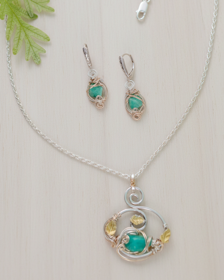 Silver jewelry set with turquoise stones on a white background