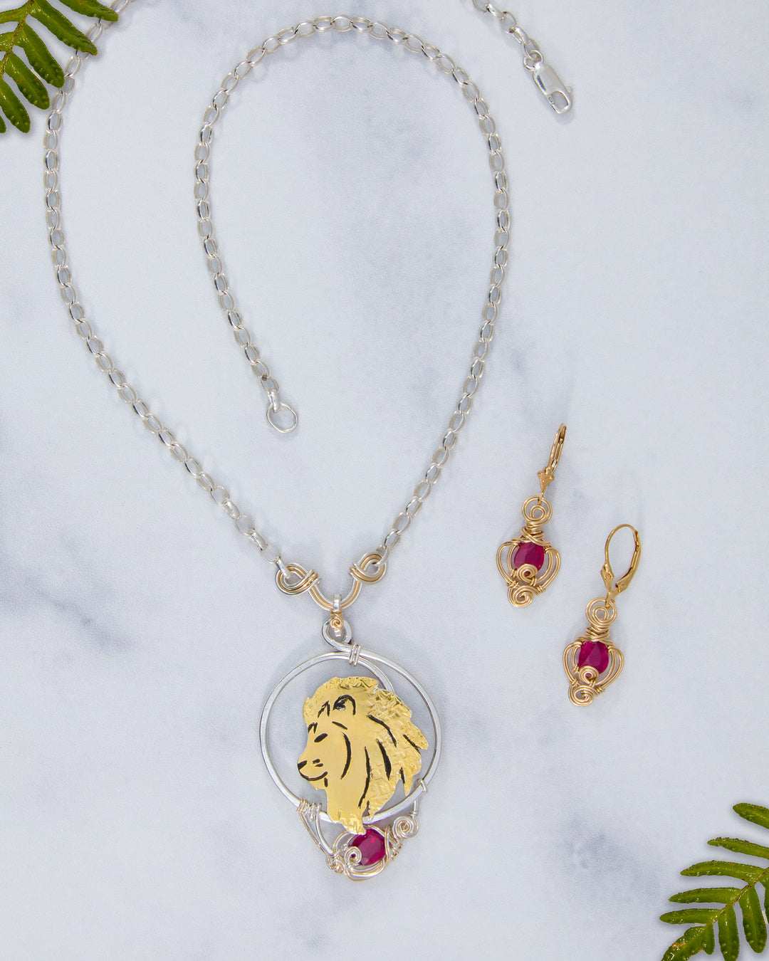 Jewelry set with lion pendant necklace and earrings on a white background